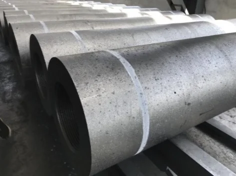 Rows of graphite electrodes in storage, showing the threaded socket at the end of each column