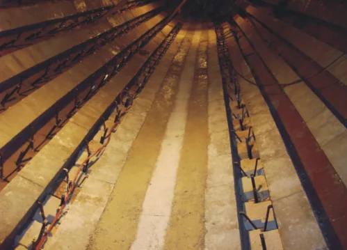 Rotary kiln interior with rows of steel anchors between refractory lining sections