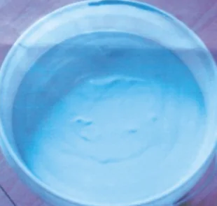 Open container of pale-blue boron nitride non-wetting coating paste