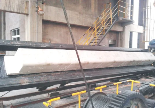 Long precast door-lining block resting on a coke oven door frame at the battery