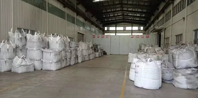 Warehouse aisle lined with rows of filled jumbo bags