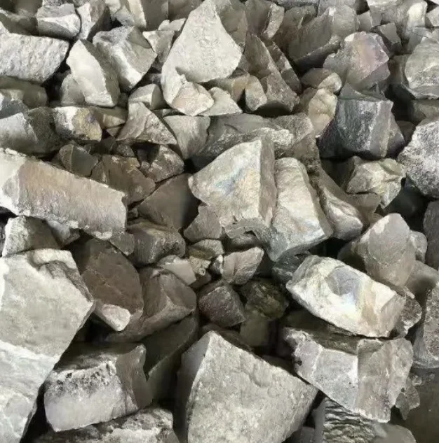 Close-up of a pile of silvery-grey alloy lumps with a metallic sheen